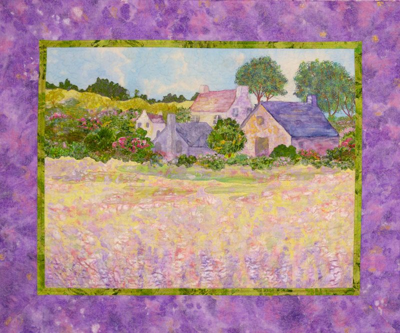 landscape art quilt of a garden scene and village